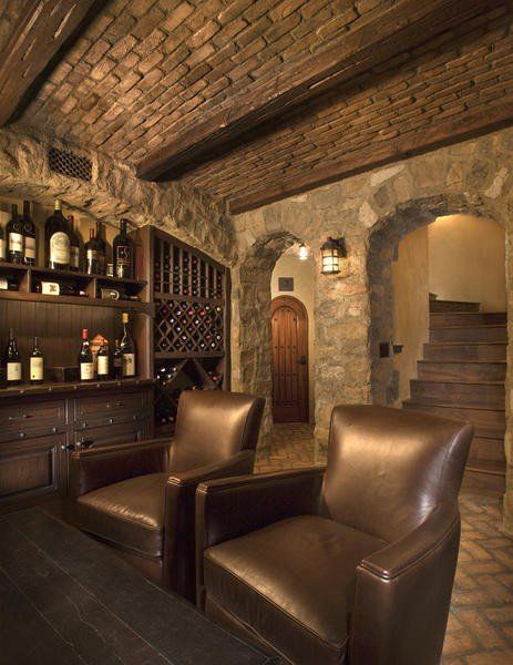 a wine cellar with two brown leather chairs