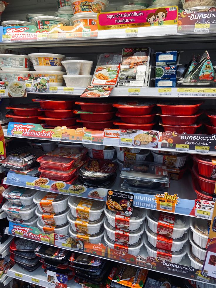 shelves in a grocery store filled with lots of food and containers on the shelf for sale