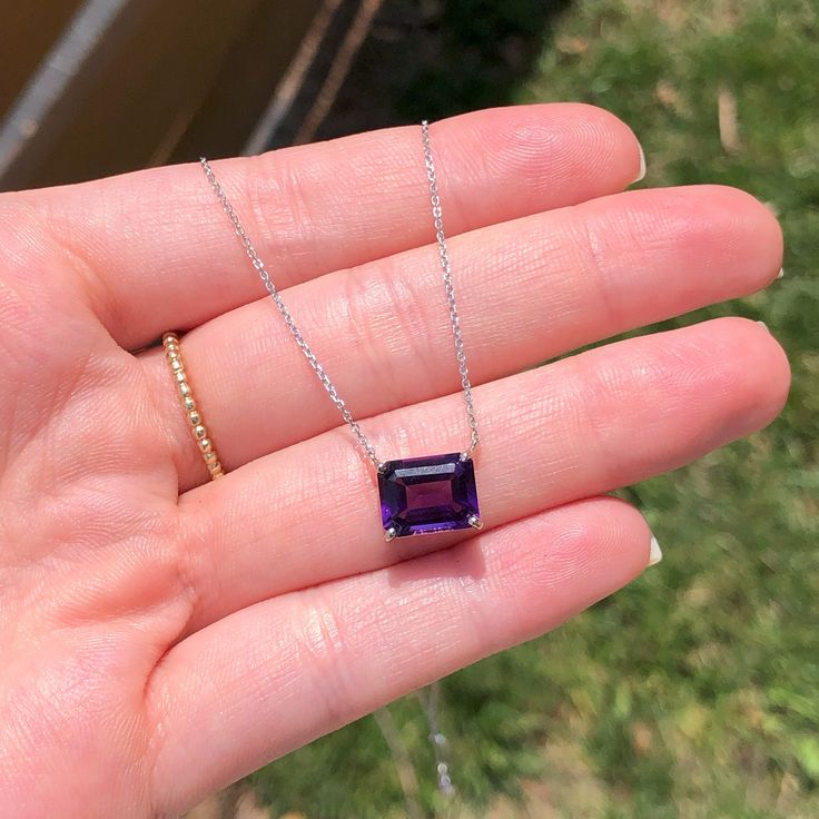 This gorgeous solitaire pendant features an emerald cut 10x8mm amethyst set in a solid 14k white, yellow, or rose gold setting. A perfect birthday gift for February babies, this magnificent purple gemstone will make any outfit sparkle and shine. Let your beauty shine! Choose between a 16" or 18" chain so we can make sure your pendant is perfectly centered!