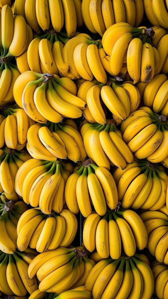 many bunches of bananas are stacked on top of each other in order to be sold