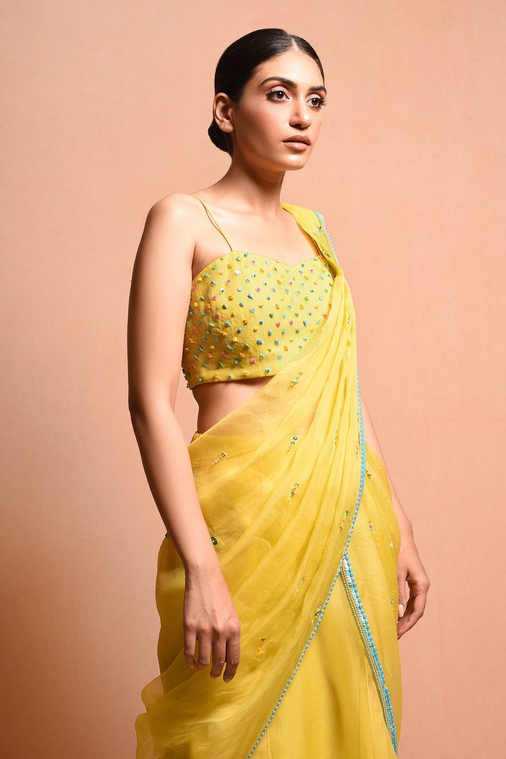 Yellow pre-stitched saree with pleated detail and embellished bugle beads, contrast border and drape detail. Paired with crystal, beads, sequin embellished cape and embellished blouse.
Component: 3
Embellished
Neckline: V neck
Sleeve Length: Three quarter
Fabric: Silk Organza
Color: Yellow
Sequin, bugle bead work
Pleated pallu - Aza Fashions Saree Gown, Embellished Neckline, Drape Saree, Yellow Silk, Embellished Blouse, Bugle Beads, Silk Organza, Yellow Fabric, Set For Women