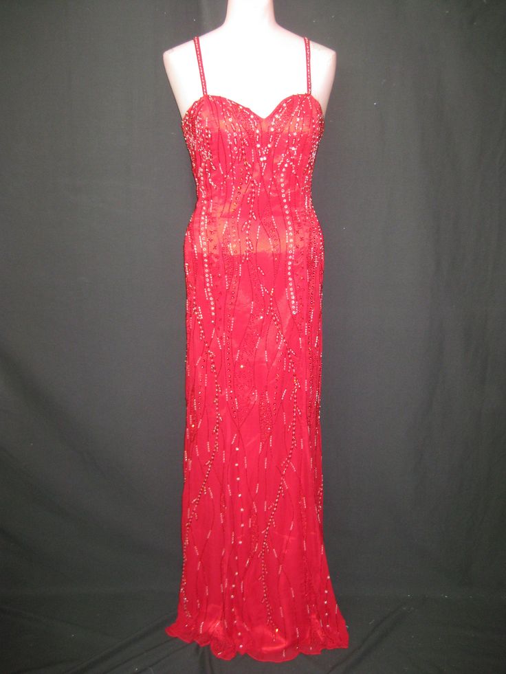 "This beautiful long red gown has red and silver beading. It is fitted along the body through the hips and flares at the very bottom.  It has a sweetheart neckline and bare back with straps across it.  This gown is in excellent condition and comes in different sizes.  Measurements for this gown in red/silver are :                                                                                                                                                   Black/silver Size-4 Red Gown For Pageant During Prom Season, Sweetheart Neckline Evening Dress With Fitted Bodice For Pageant, Pageant Evening Dress With Corset Back And Fitted Bodice, Floor-length Evening Dress With Fitted Bodice For Pageants, Red Sleeveless Gown For Pageant, Red Gown For Pageant And Prom Season, Red Sleeveless Gown For Pageants, Sweetheart Neckline Gown With Beaded Straps And Fitted Bodice, Sparkling Floor-length Gown For Pageants