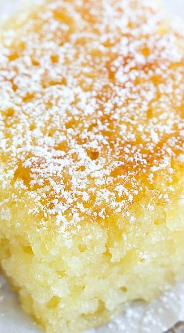 a close up of a piece of cake on a plate with sugar sprinkled on top