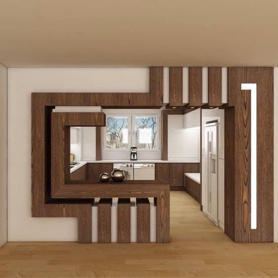 the interior of a modern kitchen with wood accents on the walls and wooden flooring