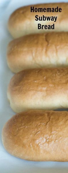 four loaves of bread sitting on top of a white tray with the words homemade subway bread