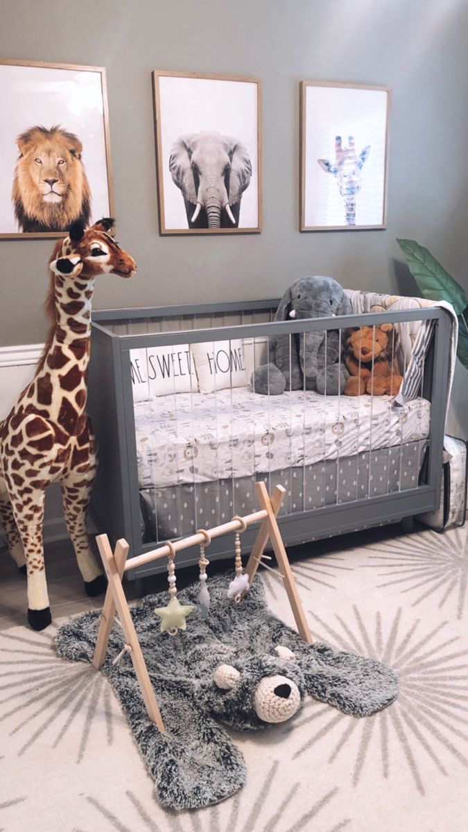 a giraffe statue standing next to a baby crib