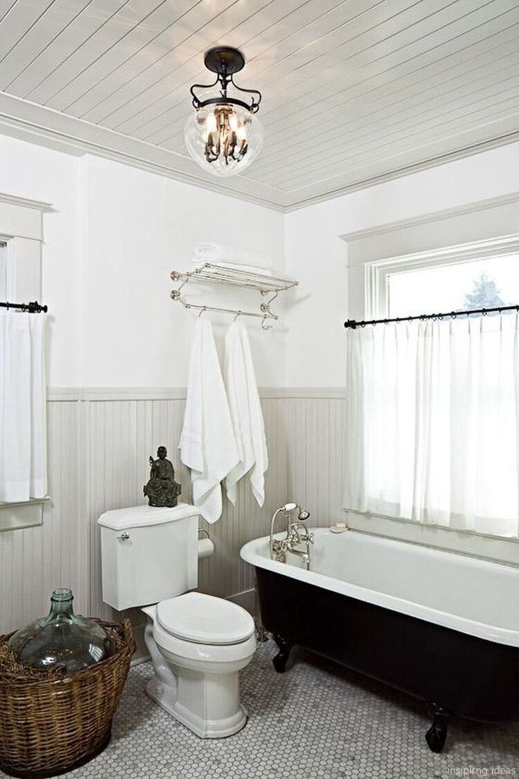 a bathroom with a tub, toilet and sink