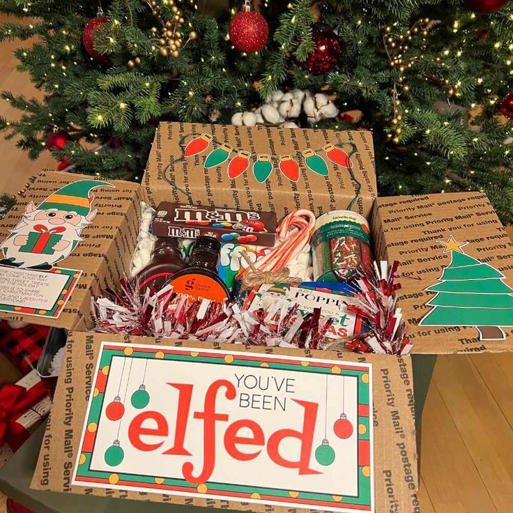 a christmas tree is decorated with boxes and candy