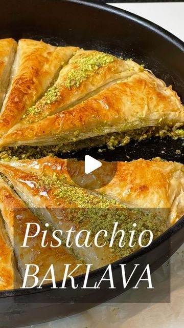 pistachio baklaa in a cast iron skillet with text overlay