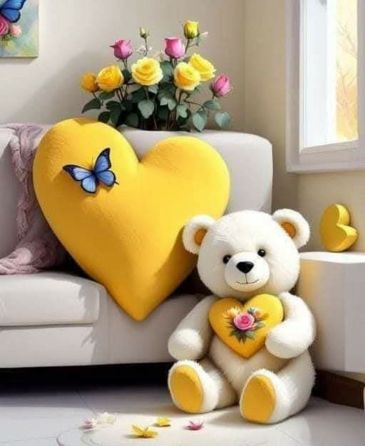 a white teddy bear sitting next to a heart shaped pillow on a couch with flowers