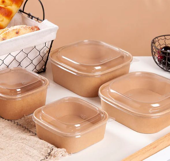 four plastic containers on a table with bread in the background