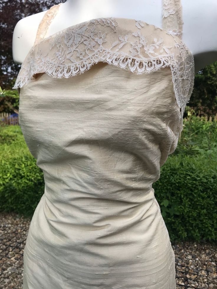 "Beautiful handmade bridal dress made using vintage fabric. Laces up at the back . Has lace shoulder straps and a split on the skirt.  Measured flat Chest 17\" Waist 14\"-16\" Pit to hem 46\" Fully lined" Cream Sleeveless Evening Dress, Sleeveless Lace Dress With Fitted Bodice And Lace Trim, Fitted Bodice Evening Dress With Back Opening For Wedding, Wedding Evening Dress With Back Opening And Fitted Bodice, Elegant Wedding Dress With Delicate Lace And Fitted Bodice, Classic Fitted Dress With Scalloped Lace, Fitted Evening Dress With Lined Bodice For Wedding, Fitted Evening Wedding Dress With Lace Trim, Elegant Wedding Dress With Lace Trim And Fitted Bodice