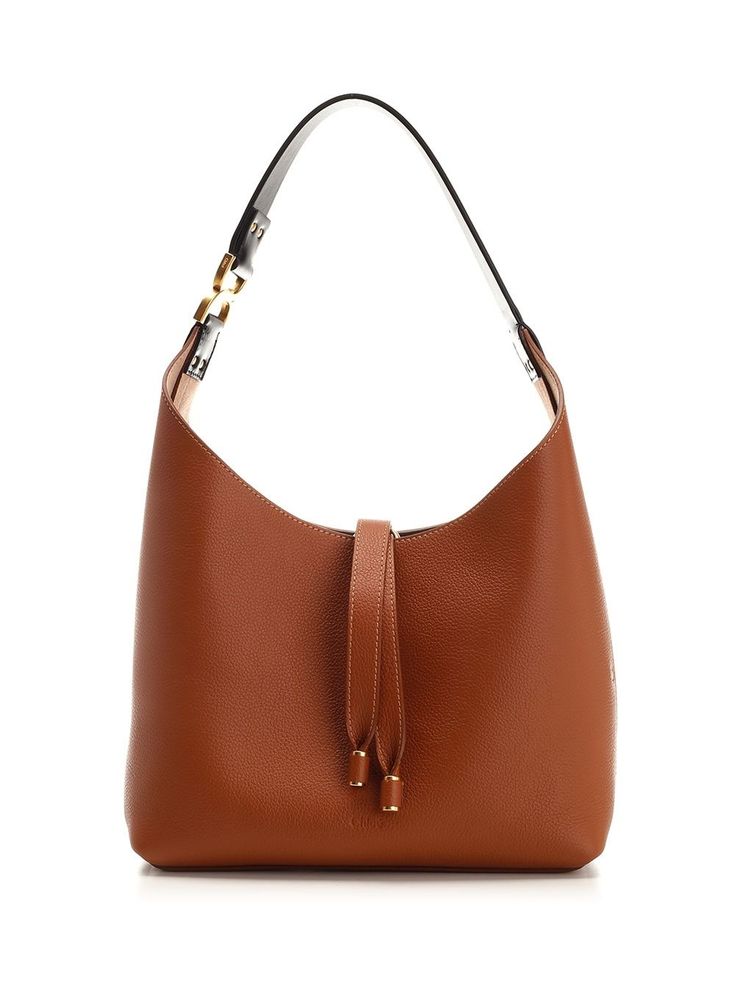 Small "Marcie" hobo bag in brown full grain leather from Chloé, with top closure with leather laces, suede interior, internal pocket, metallic "C" detail on the shoulder strap. Brown Calf Leather Bucket Bag With Gold-tone Hardware, Brown Calf Leather Bucket Bag With Leather Lining, Brown Shoulder Bag With Metal Hardware For Luxury Everyday, Brown Metal Hardware Shoulder Bag For Everyday Luxury, Luxury Brown Bucket Bag With Metal Hardware, Formal Brown Leather Hobo Bag, Luxury Cognac Hobo Bag With Leather Handles, Classic Brown Calf Leather Hobo Bag, Brown Calf Leather Bucket Bag For Office