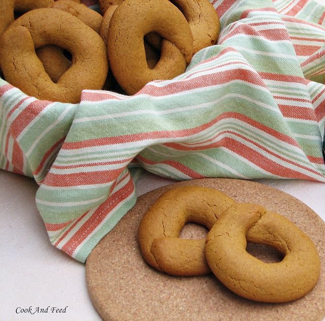 there are some cookies and doughnuts next to each other on a tablecloth