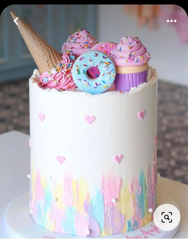 there is a cake decorated with donuts and sprinkles