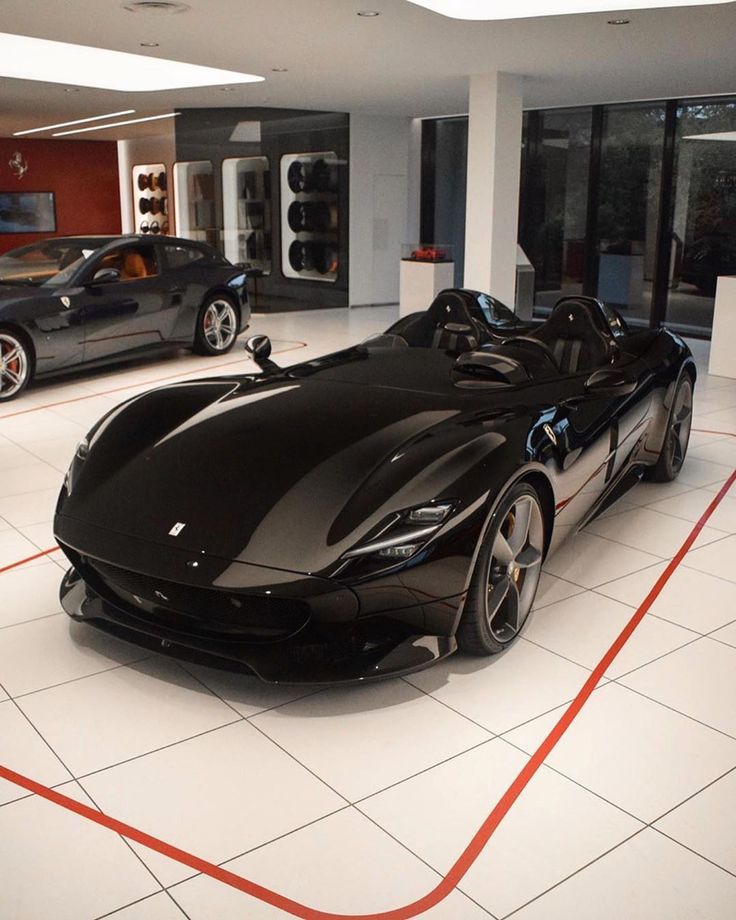 a black sports car is parked in a showroom