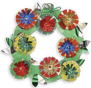 a wreath made out of paper flowers and ribbons