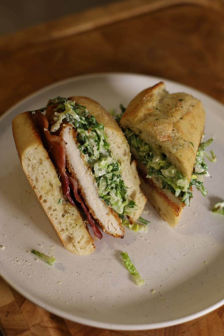 two sandwiches are sitting on a white plate