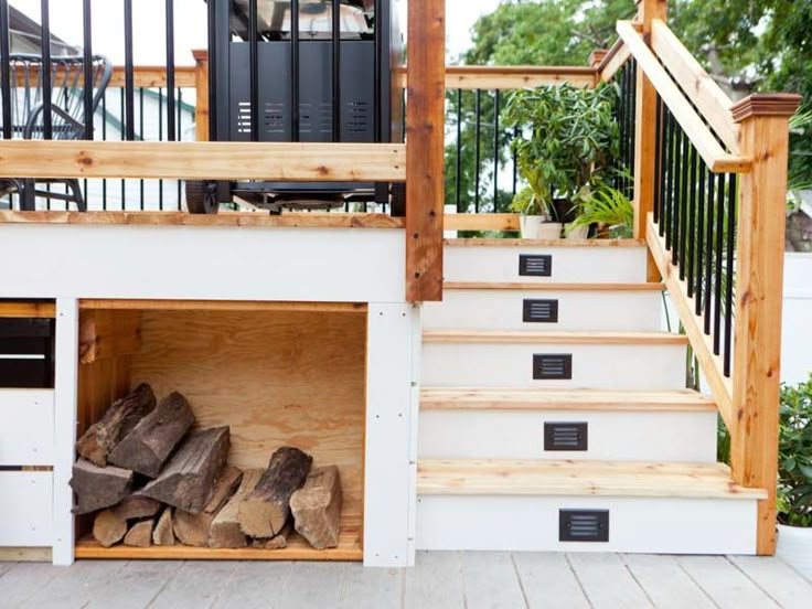 the firewood is stacked on top of the stairs