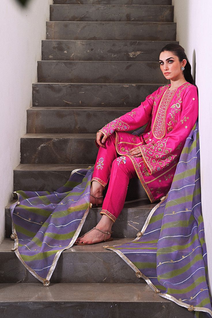 Channeling the old world charm of a kalidar kurta paired with shalwar, Serina is a striking hot pink number cut from pure rawsilk. The undulating trail of the geometric lime green and lavender contrasting organza dupatta hones in the ethereal aura. Model height: 5'3 Length: 38" Cut: relaxed fit In this price range, the Pink Naqshi Salwar Kameez For Wedding, Festive Tissue Silk Salwar Kameez With Naqshi, Pink Naqshi Anarkali Set For Diwali, Festive Pink Sharara With Naqshi Details, Festive Pink Sharara With Naqshi Embroidery, Festive Pink Sharara With Naqshi, Eid Unstitched Tissue Silk Suit With Naqshi, Festive Pink Anarkali Set With Naqshi Detail, Pink Naqshi Sharara For Diwali