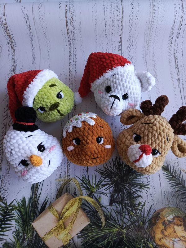 four crocheted christmas ornaments are sitting next to each other