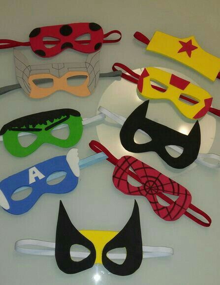 a bunch of masks are sitting on a table together, all in different colors and shapes