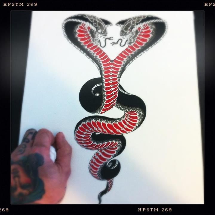 a drawing of a red and black snake on white paper