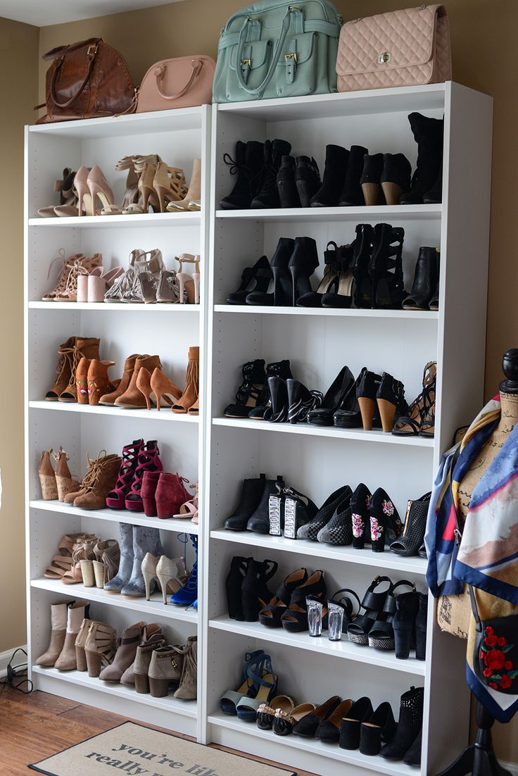 a white bookcase filled with lots of different types of women's shoes and purses