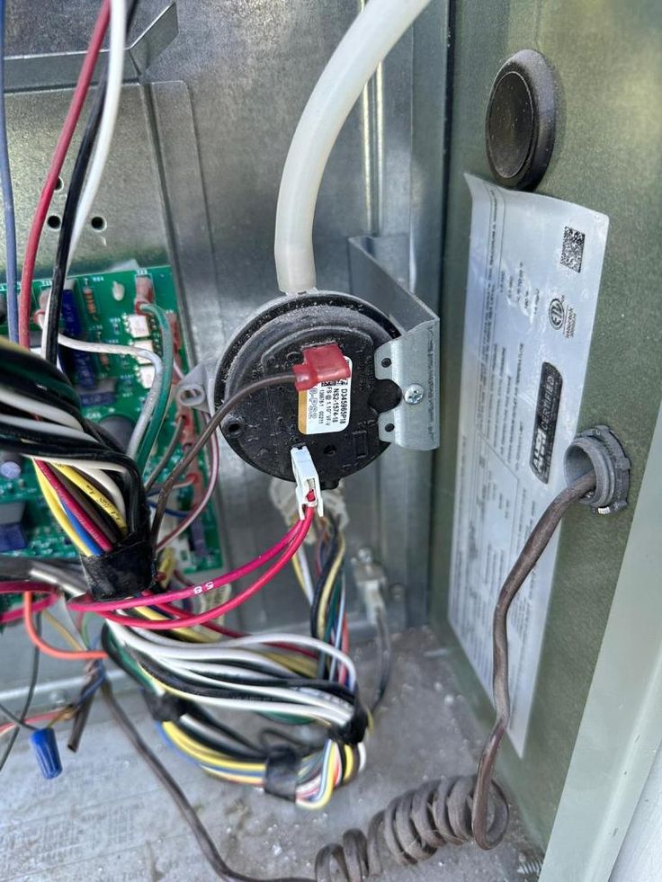 the inside of an electrical panel with wires attached to it