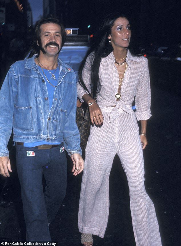 the man and woman are dressed up in denim outfits, posing for a photo together