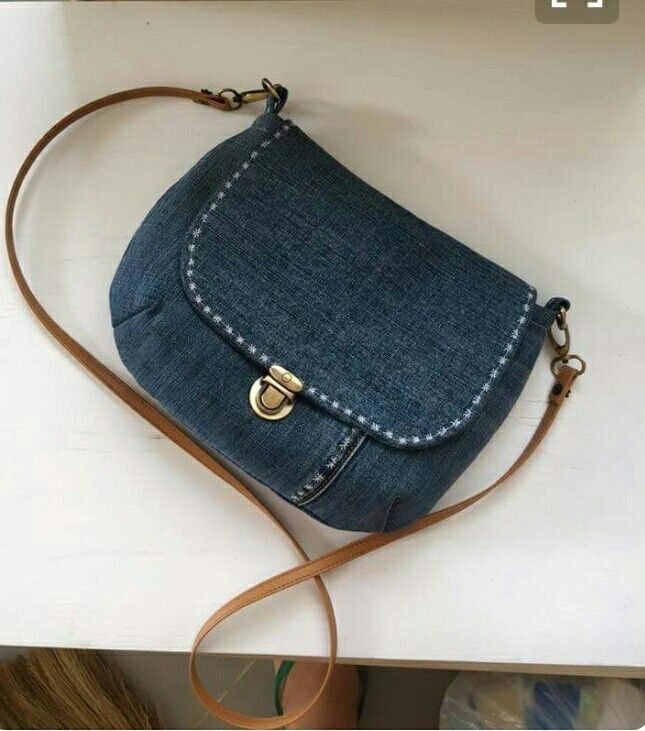 a denim purse sitting on top of a table