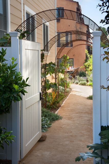 an open door leading to a house with plants growing on the outside and in front