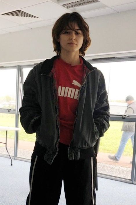 a woman standing in an airport with her hands on her hips