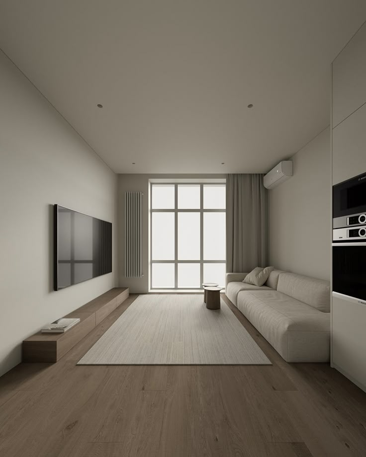 an empty living room with white walls and wood flooring