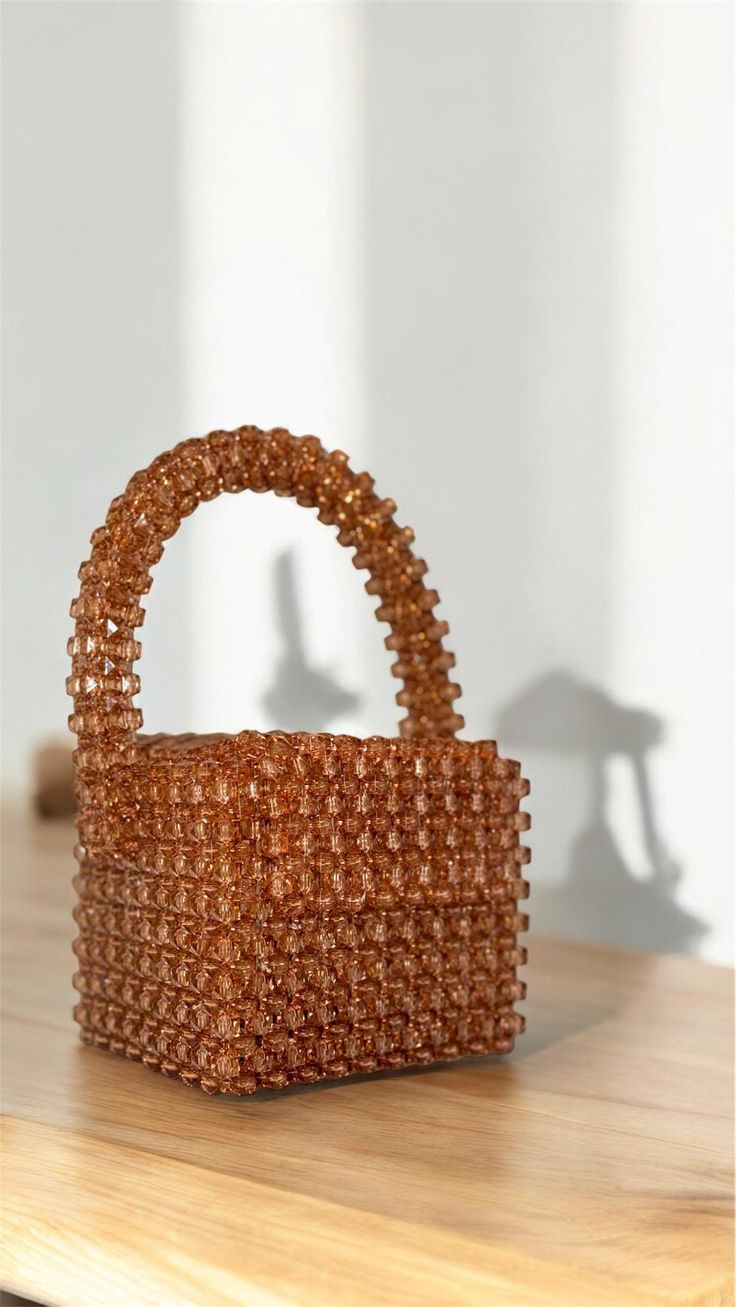 Introducing our handcrafted brown beaded bag--a blend of elegance and craftsmanship. Perfect for any occasion, this unique accessory is meticulously handmade with premium beads. It features a secure clasp and a soft, durable lining. Each piece is crafted with care, ensuring no two bags are exactly alike. Ideal for adding a touch of sophistication to your wardrobe. Order yours today and elevate your style! Handmade Brown Evening Bag For Party, Brown Beaded Handheld Bag, Handheld Brown Beaded Bag, Beaded Brown Bags As Fashion Accessory, Handmade Brown Handheld Evening Bag, Beaded Brown Evening Bag For Party, Brown Handheld Handmade Evening Bag, Elegant Beaded Brown Bag, Embellished Brown Evening Bag For Party