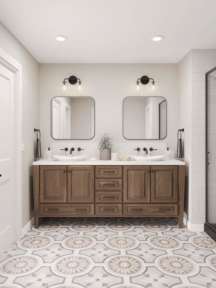 a large bathroom with two sinks and mirrors on the wall above it is tiled flooring