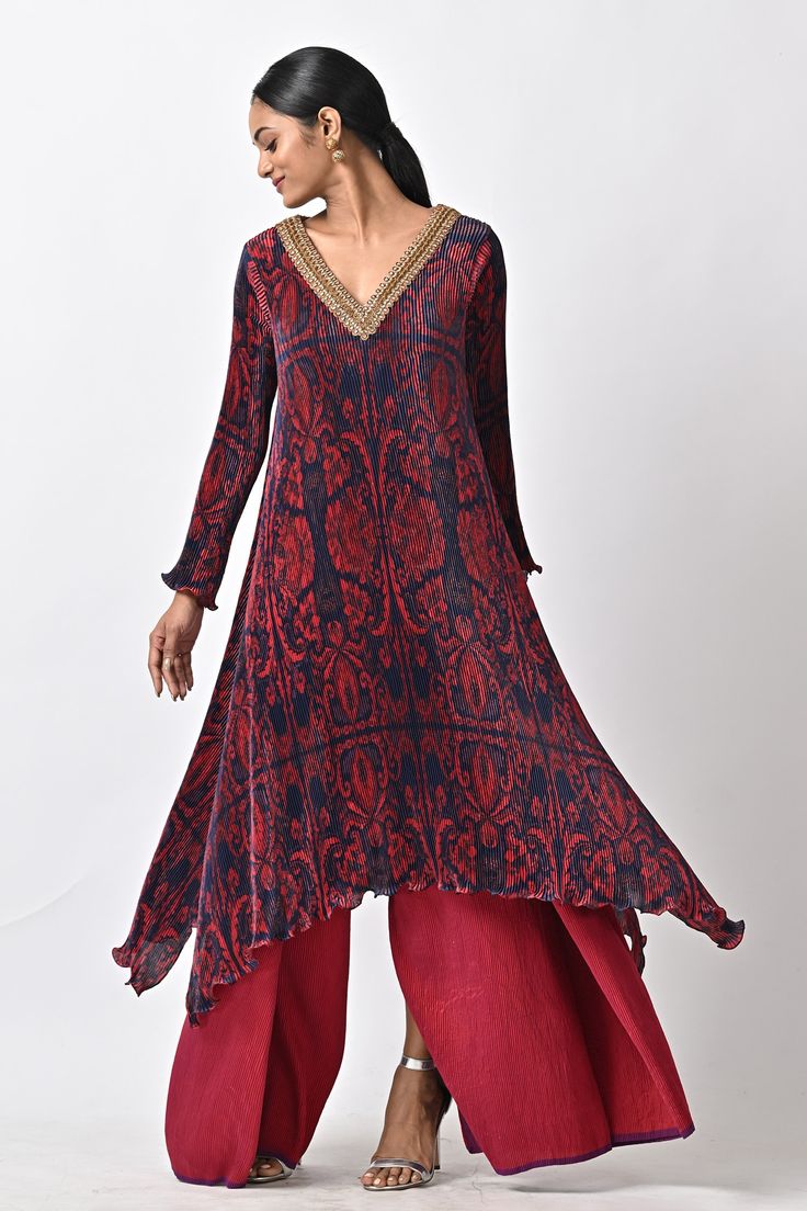 Maroon kaftan with abstract print, pleats and hand embroidery.
Components: 1
Pattern: Printed, Hand Embroidered
Type Of Work: Abstract
Neckline: V Neck
Sleeve Type: Full
Fabric: Pleated polyester mix
Color: Maroon
Other Details: 
Note : Pant and dupatta worn by the model are not for sale.
Occasion: Mehendi and Haldi,Sangeet - Aza Fashions Festive Silk Bohemian Anarkali Set, Transitional Anarkali Kaftan With Long Sleeves, Bohemian Silk Anarkali Set With Resham Embroidery, Transitional Long Sleeve Anarkali Kaftan, Bohemian Semi-stitched Silk Anarkali Set, Festive Ikat Print Tunic Dress, Bohemian Georgette Dresses For Transitional Season, Bohemian Tunic With Printed Motifs For Festive Occasions, Transitional Bohemian Georgette Dresses