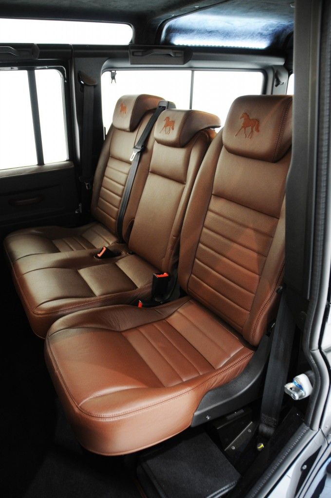 the interior of a vehicle with brown leather seats and black trims on it's sides