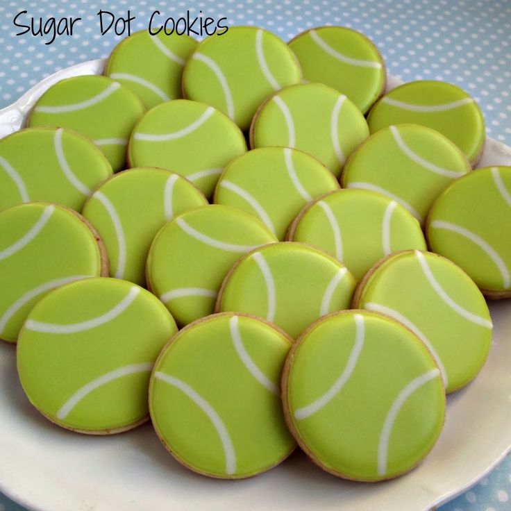 a white plate topped with green and white tennis cookies