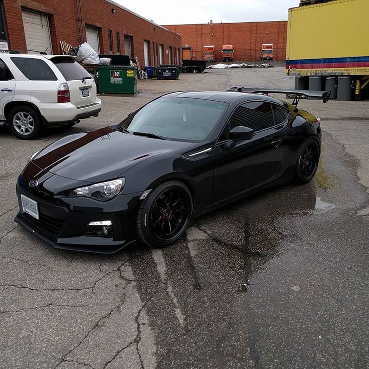 a black sports car parked in a parking lot