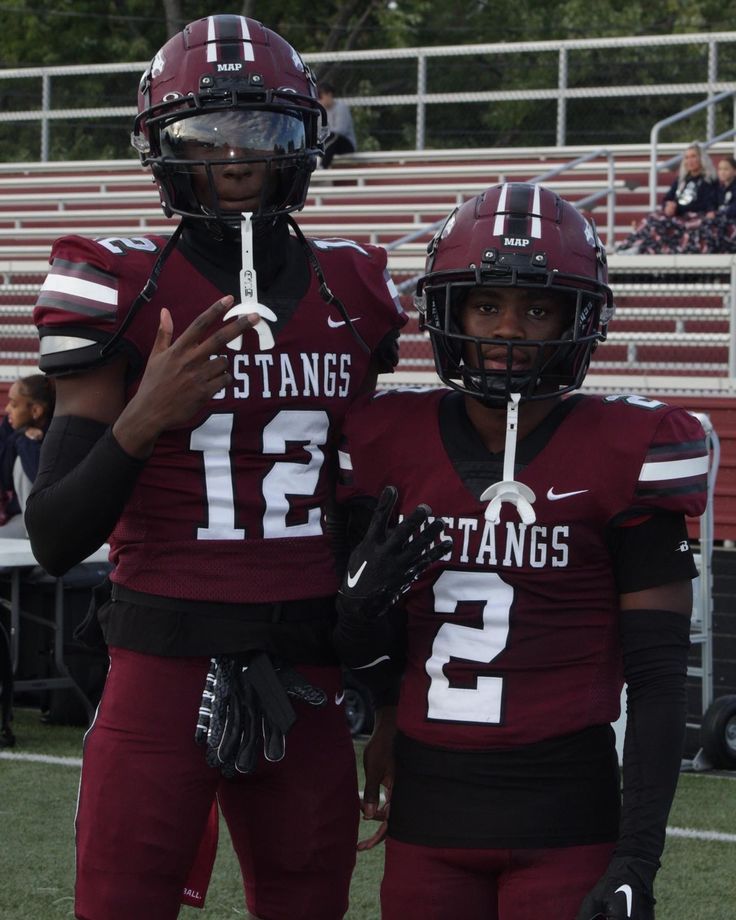 two football players standing next to each other