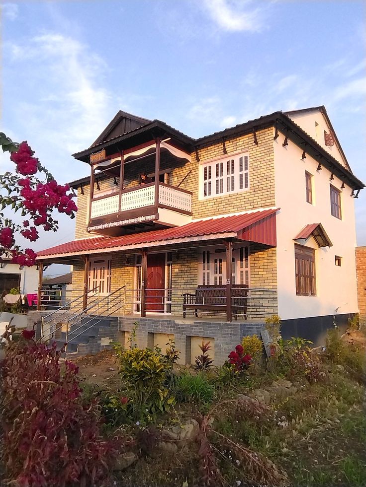 a house with red flowers in front of it