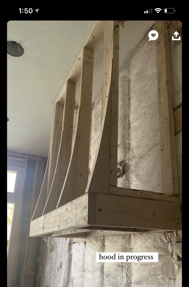 an unfinished kitchen hood with the words wood in progress on it's back wall