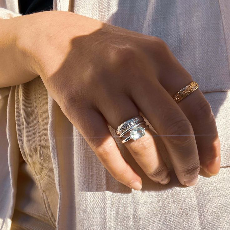 a close up of a person's hand wearing two rings