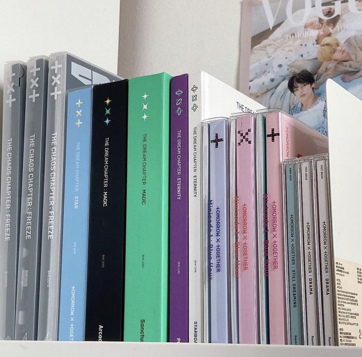 a row of books sitting on top of a white shelf