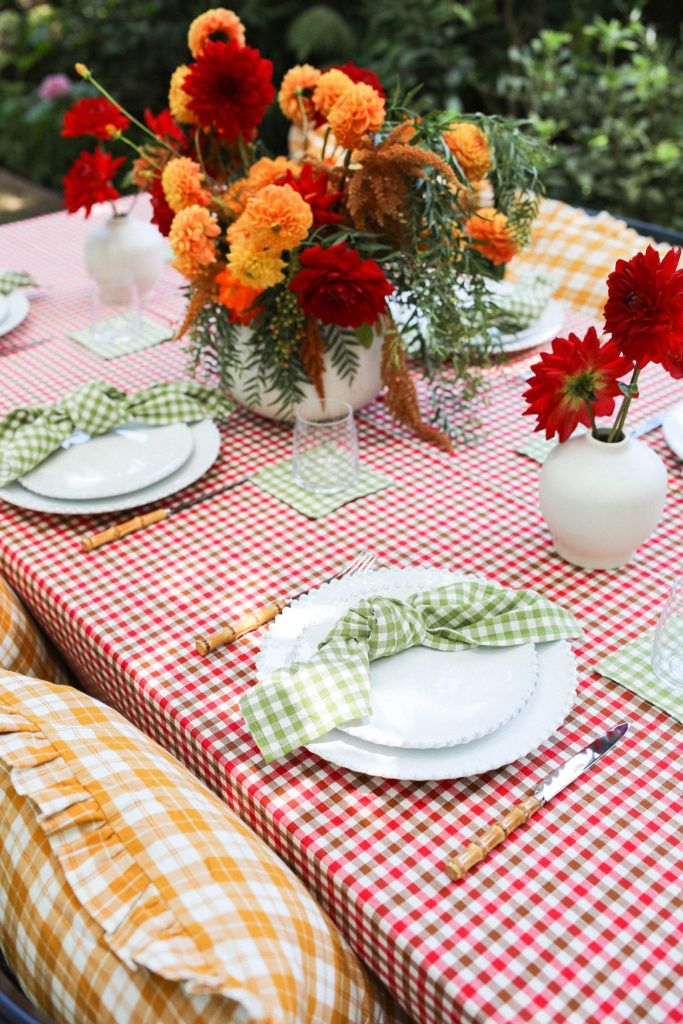 the table is set with flowers and plates