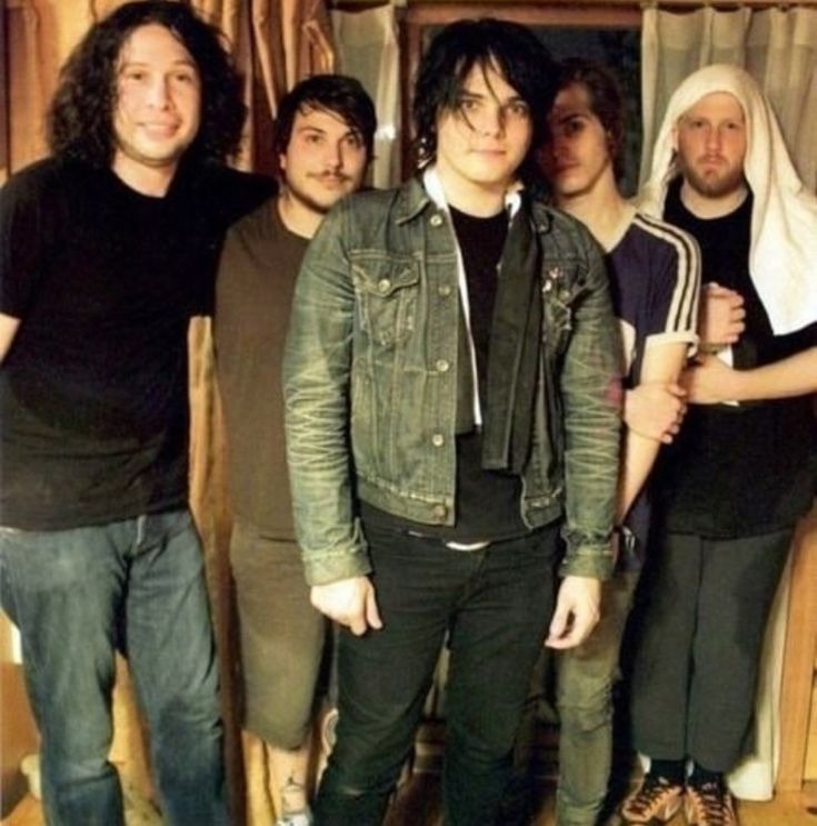 a group of young men standing next to each other in front of a wooden door