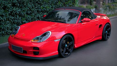 a red sports car is parked on the street