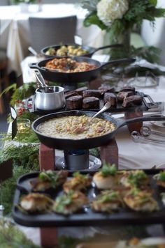 an assortment of food is displayed on a buffet table