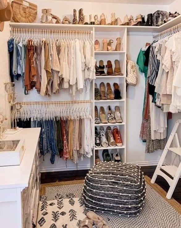 an organized closet with shoes, clothes and other items on the shelves in front of it